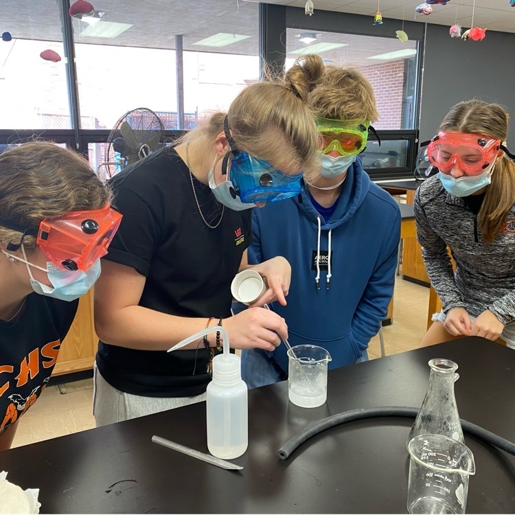 chemistry students performing chemistry labs